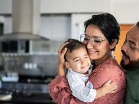 Father mother and infant son in their kitchen