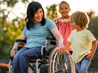 Mom in a wheelchair walking with her children