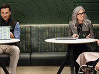 Three Securian Financial associates working in a green pod meeting area, one of them is in a wheelchair