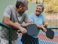 Senior couple take break from pickleball game