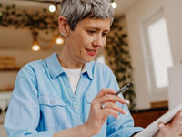 Woman reviewing documents on her digital tablet