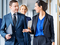 Women business leader talking in hallway