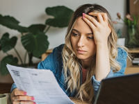 Worried young woman reviewing finances