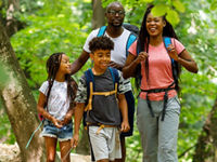 Young family hiking in the woods