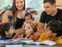 Young family sitting in a cabin